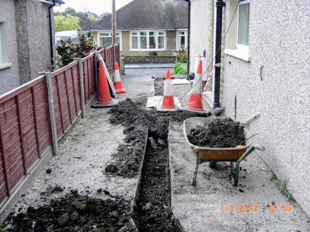 Drainage trench excavated between residential properties