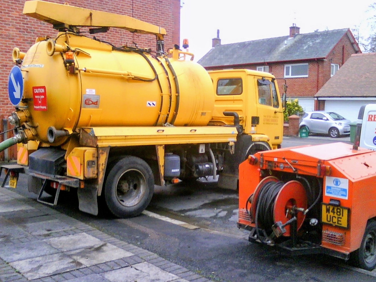 Retro-Cleanse tanker with jetting trailer on a residential street