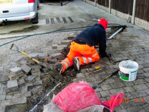 Retro-Cleanse groundworks operative working on paving